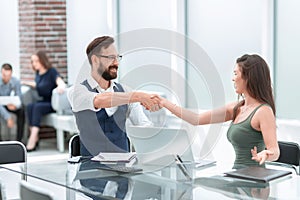 Handshake business partners at the office Desk
