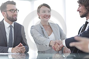 Handshake business partners for their Desk