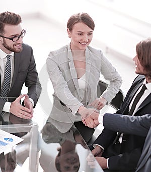 Handshake business partners for their Desk