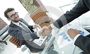 Handshake business partners at your Desk