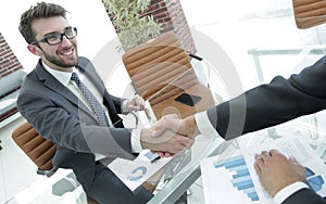 Handshake business partners at your Desk