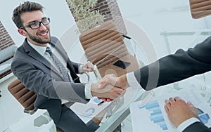 Handshake business partners at your Desk