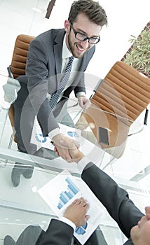 Handshake business partners at your Desk