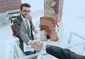 Handshake business partners at your Desk