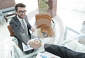 Handshake business partners at your Desk