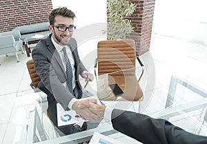 Handshake business partners at your Desk