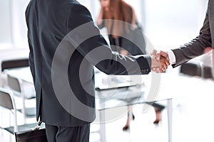 handshake of business people in the background of the office