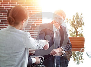 Handshake of business people at the desk