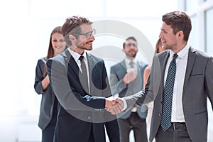 handshake business people in the office corridor