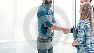 Handshake business people in the office lobby .