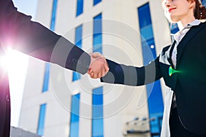 Handshake of business people over city buildings background