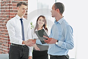 Handshake of business people standing in office