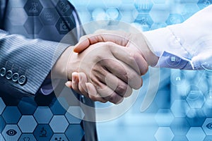 Handshake of a businessman and a doctor .