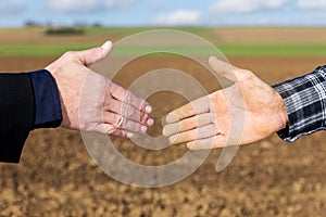 Handshake between businessman and farmer