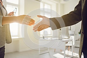 Handshake of businessmen. Female and male hand makes a handshake in the office.