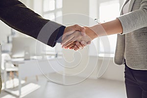 Handshake of businessmen. Female and male hand makes a handshake in the office.