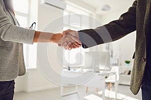 Handshake of businessmen. Female and male hand makes a handshake in the office.