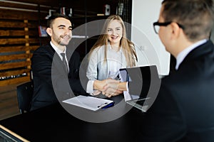 Handshake of businessmen in modern office.