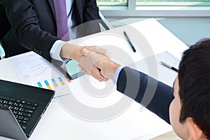 Handshake of businessmen in the office