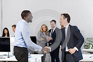 Handshake, Businessmen Shaking Hands During Meeting, Agreement In Front Of Business People Discussion Of Contract In