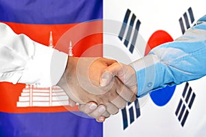 Handshake on Cambodia and South Korea flag background. Support concept