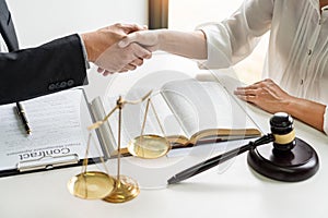 Handshake after cooperation between attorneys lawyer and clients discussing a contract agreement hope of victory over legal