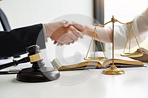 Handshake after cooperation between attorneys lawyer and clients discussing a contract agreement hope of victory over legal