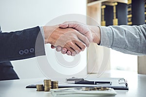 Handshake of cooperation customer and salesman after agreement,