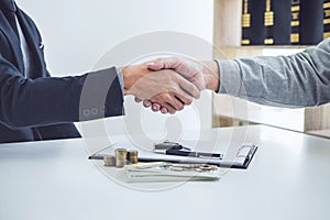 Handshake of cooperation customer and salesman after agreement,