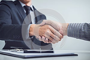 Handshake of cooperation customer and salesman after agreement, photo