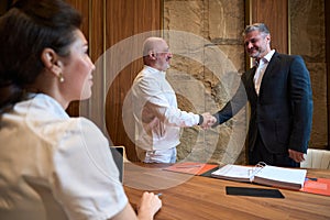 Handshake between a doctor and a patient in an office