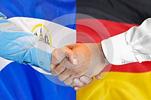 Handshake on El Salvador and Germany flag background. Support concept