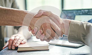 Handshake exemplifies values of trust, collaboration, and teamwork within corporate environment, emphasizing importance photo