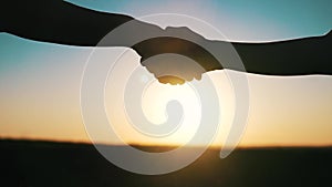 handshake farmers silhouette. agriculture business concept. close-up farmers hands silhouette shaking hands silhouette