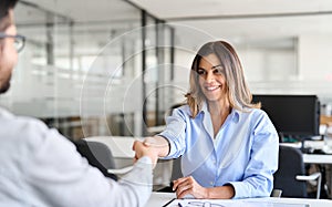 Handshake of female hr and male recruit at job interview meeting. Hiring concept