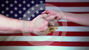 Handshake fraternal, sisterly, support on the background of the flag of the United States of America.