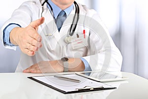 Handshake Gesture from Doctor in a white labcoat and stethoscope