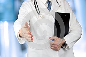 Handshake Gesture from Doctor in a white labcoat photo