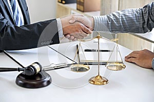 Handshake after good cooperation, Businessman Shaking hands with Professional male lawyer after discussing good deal of contract