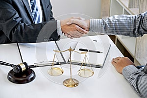 Handshake after good cooperation, Businessman Shaking hands with Professional male lawyer after discussing good deal of contract