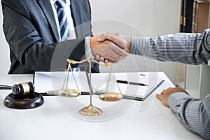Handshake after good cooperation, Businessman Shaking hands with Professional male lawyer after discussing good deal of contract