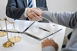 Handshake after good cooperation, Businessman Shaking hands with Professional male lawyer after discussing good deal of contract