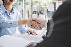 Handshake after good cooperation, Businesswoman Shaking hands with Professional male lawyer after discussing good deal of contract