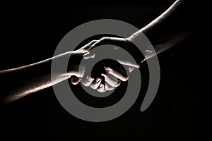 Handshake hand, arm on salvation. Close up help hand. Two hands, helping arm of a friend, teamwork. Rescue, helping