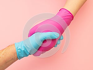 Handshake in hygienic gloves