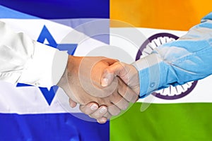 Handshake on India and Israel flag background