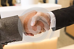 Handshake isolated on business office background