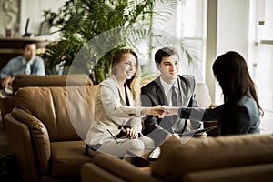 Handshake of the manager and the client after the contract discussion in the lobby of the modern office