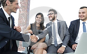 Handshake Manager and the client at a meeting in the office lobby.