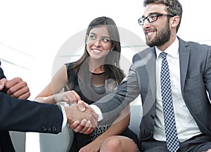 Handshake Manager and the client at a meeting in the office lobby.